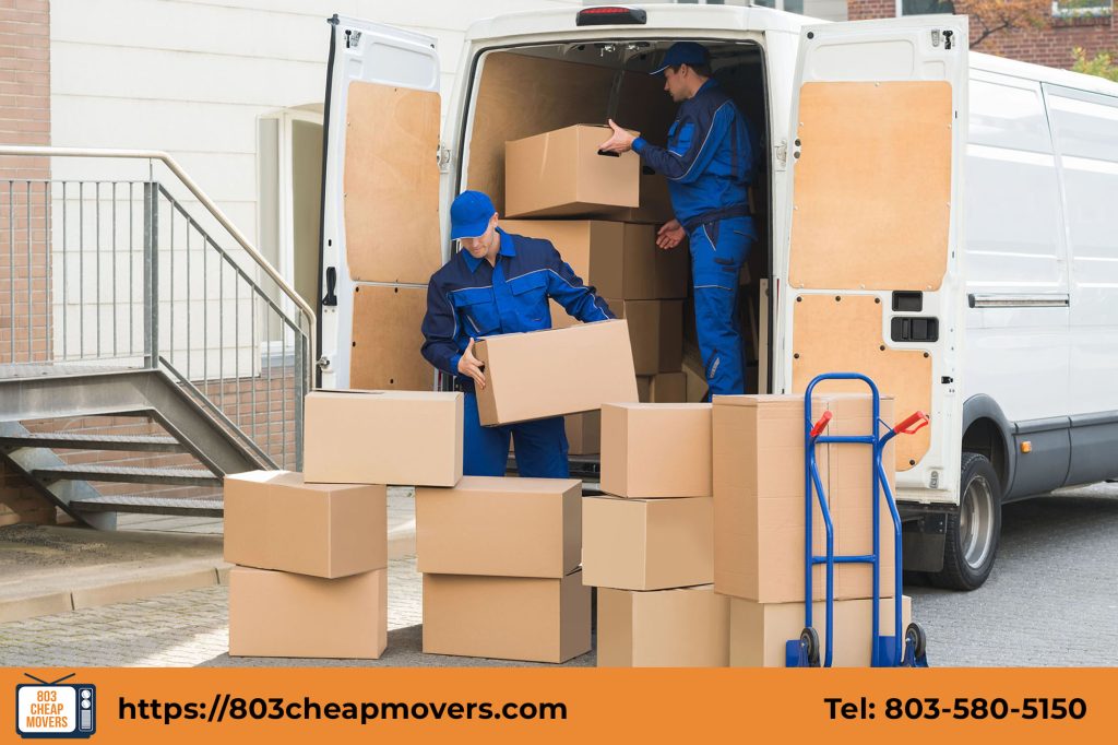 Professional movers loading boxes into a moving van using a hand truck dolly in Forest Acres SC.