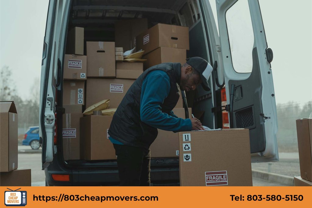 Professional mover from 803 Cheap Movers organizing boxes inside a moving van in Camden SC.